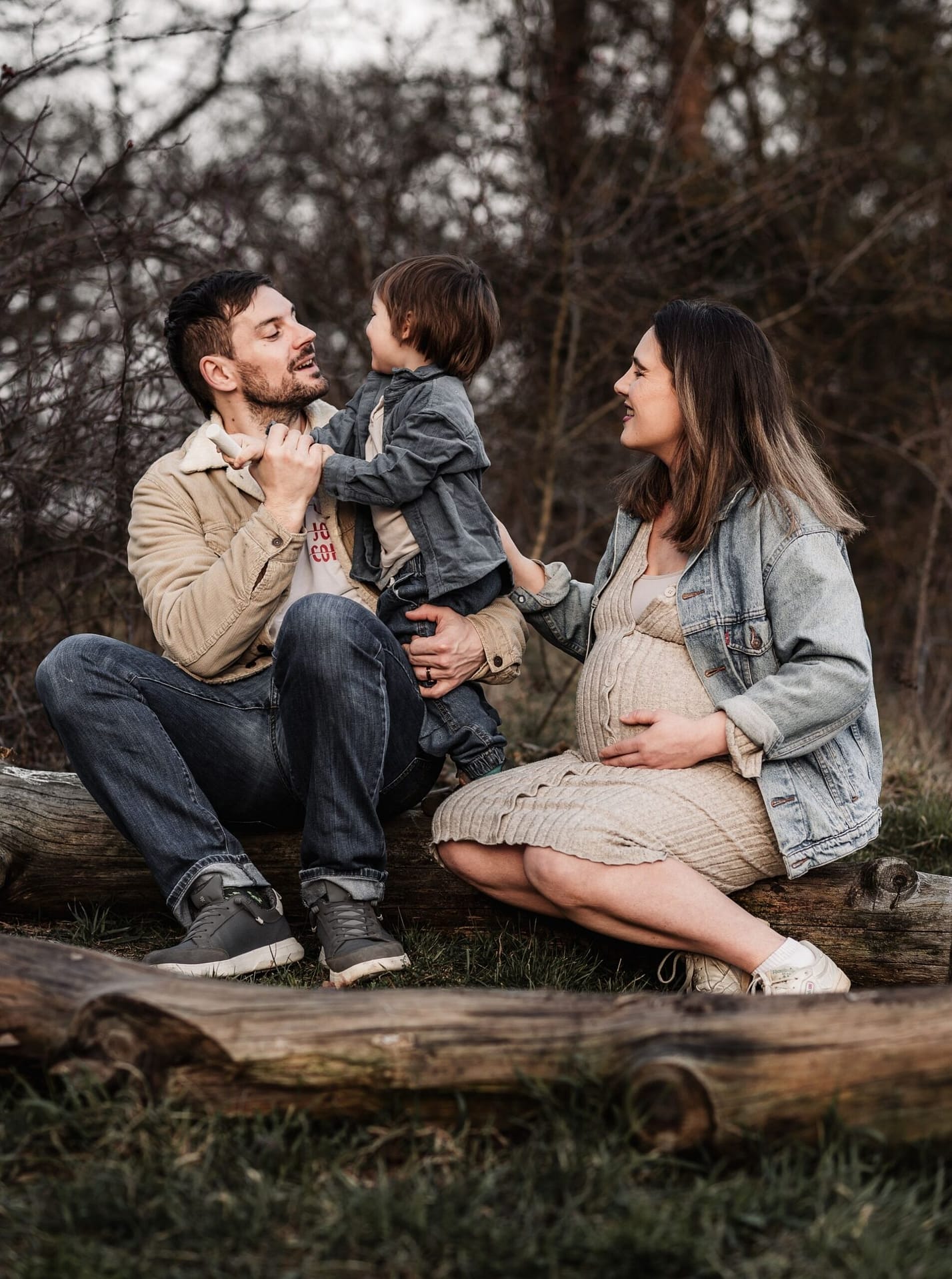 Familien draußen in der Natur beim Familien und Babybauchshooting. Sie genießen die gemeinsame Zeit im Hainberg umgeben von Wald.
