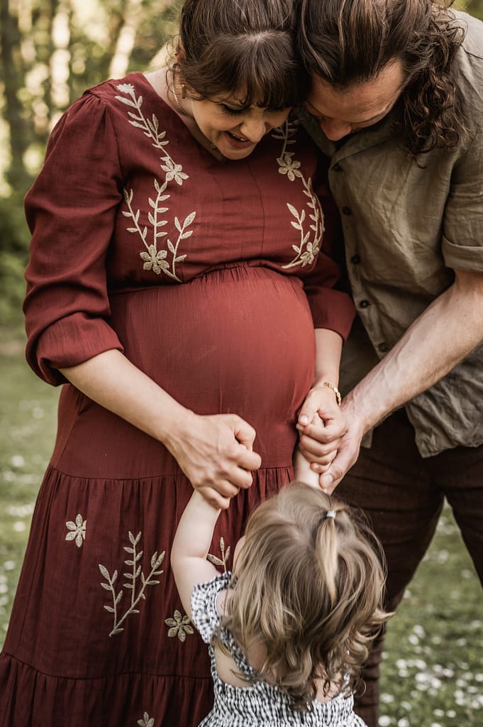 Schwangere Frau mit Partner und Kleinkind beim Babybauch-Shooting im Fürther Stadtpark